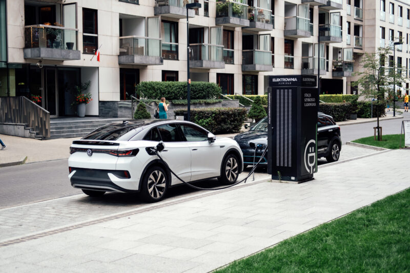 Samochody elektryczne podczas ładowania na miejskiej stacji szybkiego ładowania w Warszawie